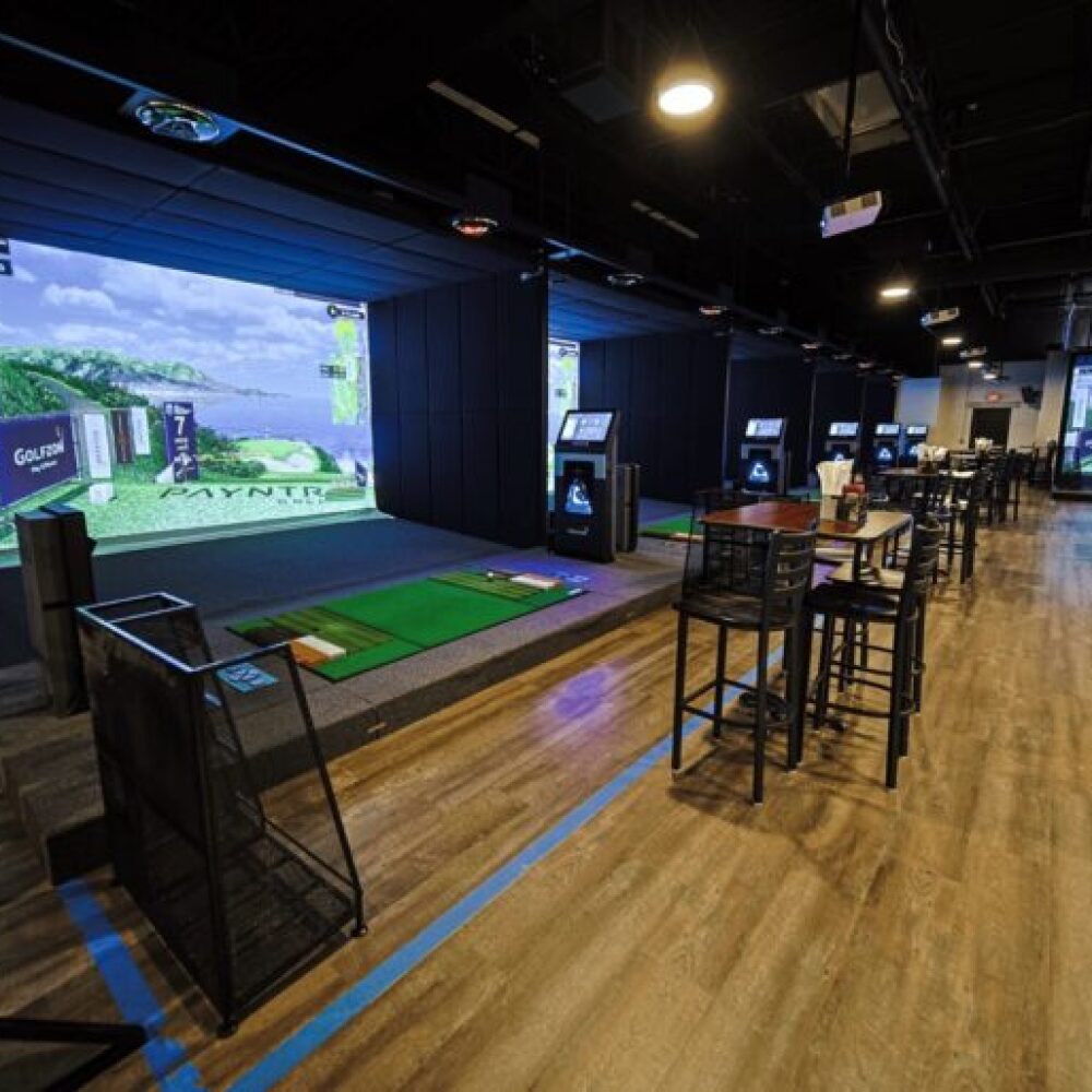 Golfzon TwoVision Commercial Setting with Multiple TwoVision Systems, Bar Stools and Tables, and Golf Clubs
