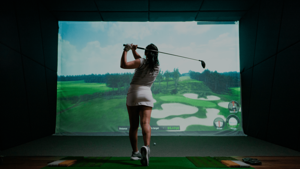 Female Golfer Swinging TwoVision Moving Swing Plate and Screen