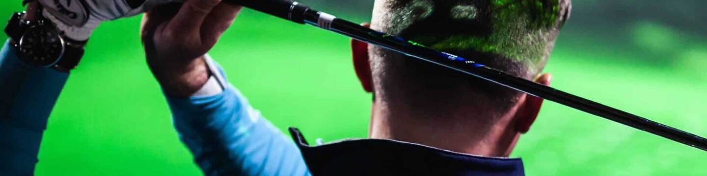 Golfer Facing Simulator Screen After Swing