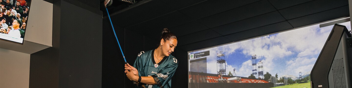 Woman playing on the TwoVision golf simulator