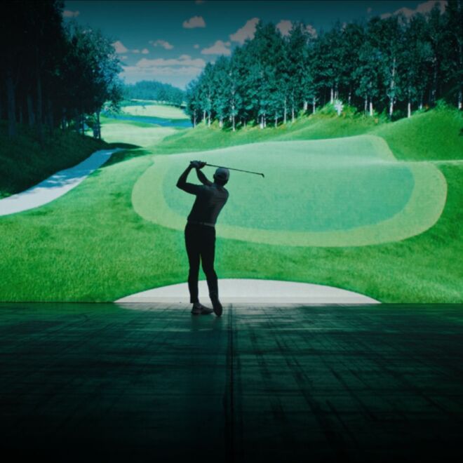 GOLFZON Tour Promotional Image of Golfer Standing In Front of Golf Course on Screen