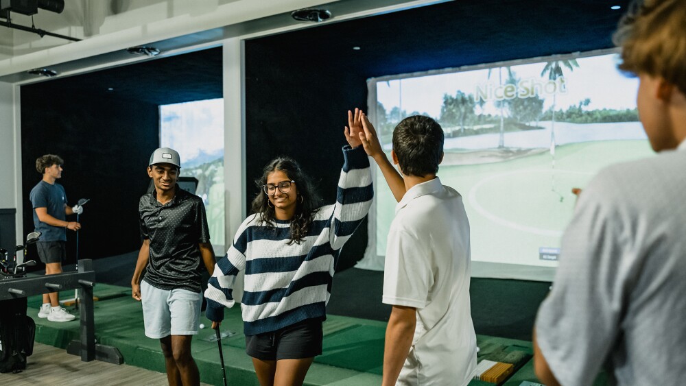 young golfers high five after a nice shot