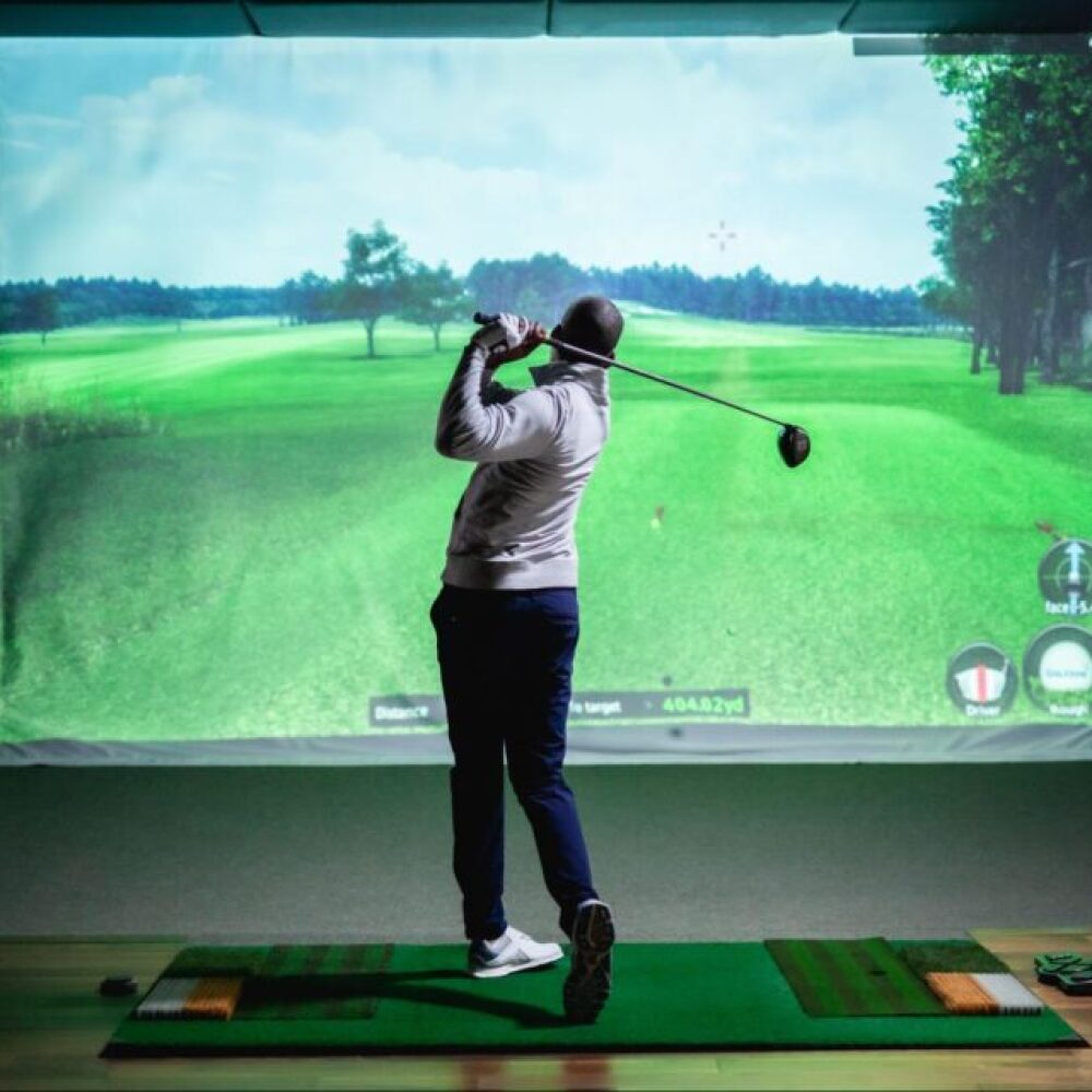 Male Golfer Swinging on TwoVision Golfzon Golf Simulator on Moving Swing Plate