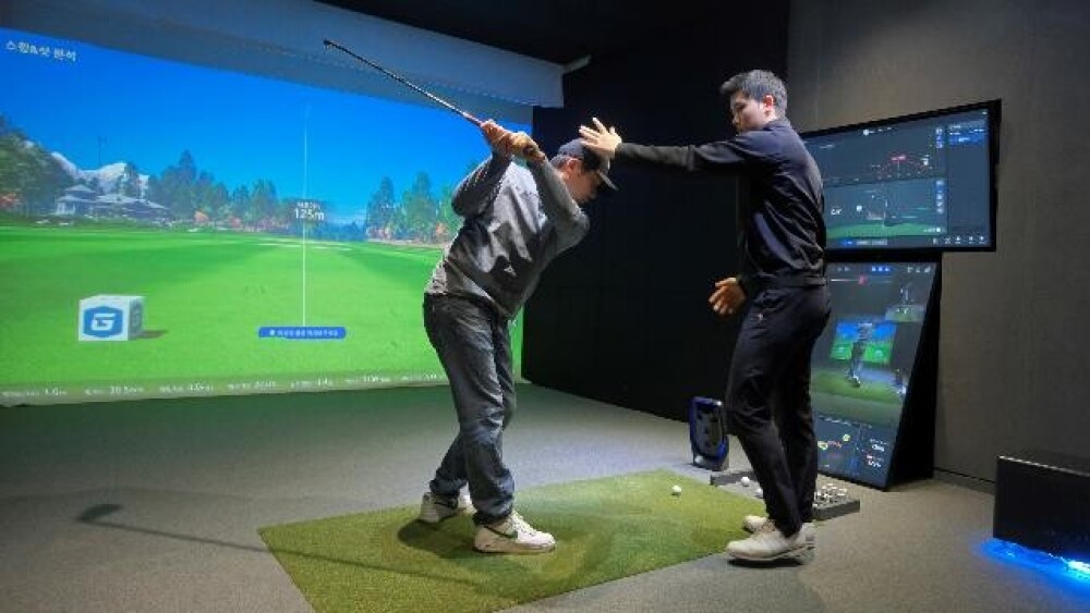 Instructor and Golfer on Next Generation Instructional Simulator