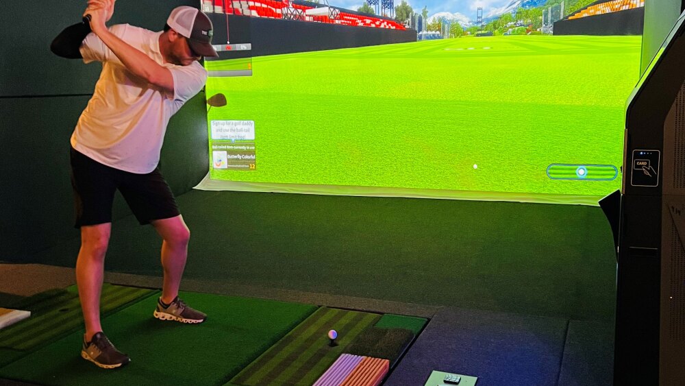 The 19th Hole in Boaz, Alabama - Golfer About to Swing on TwoVision Indoor Golf Simulator