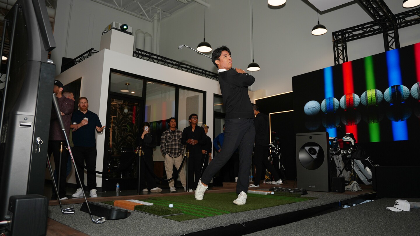 Golfer Playing On TwoVisionNX in Golf Envy Showroom LA California, People Spectating