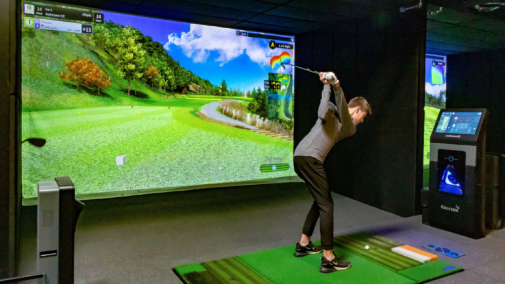 Golfer on Golfzon Golf TwoVision Simulator About to Swing