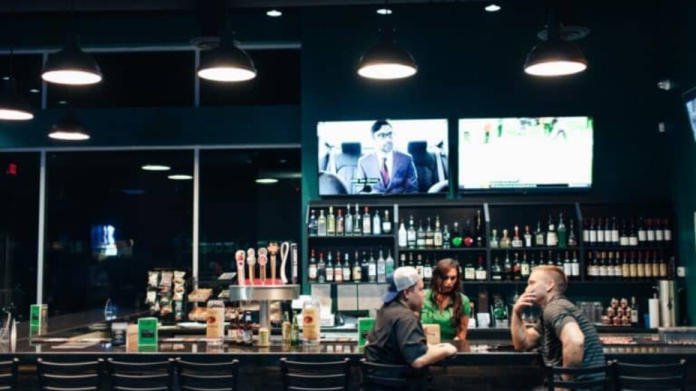 Sports Bar with Bartender and Two Guys Sitting and Talking