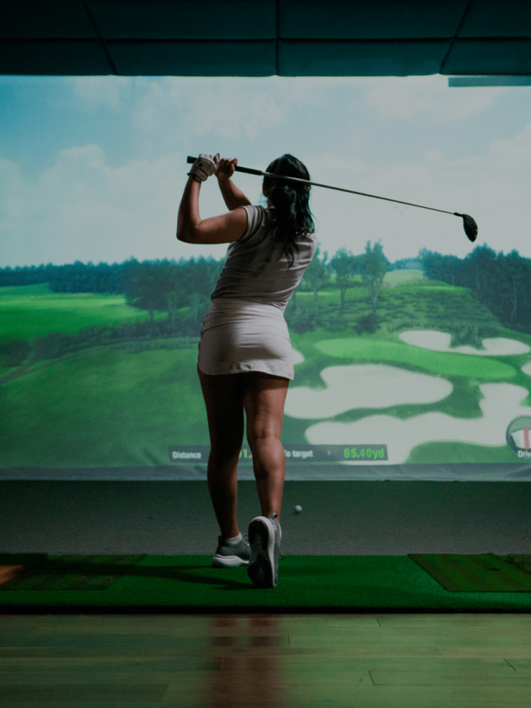 Female Golfer Swinging TwoVision Moving Swing Plate and Screen