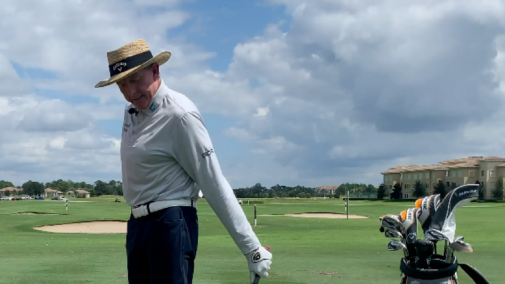 David Leadbetter with Golf Club and Golf Balls Showing Tip 1