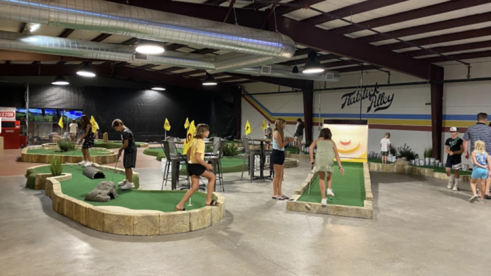 Children Playing Indoor Mini Golf