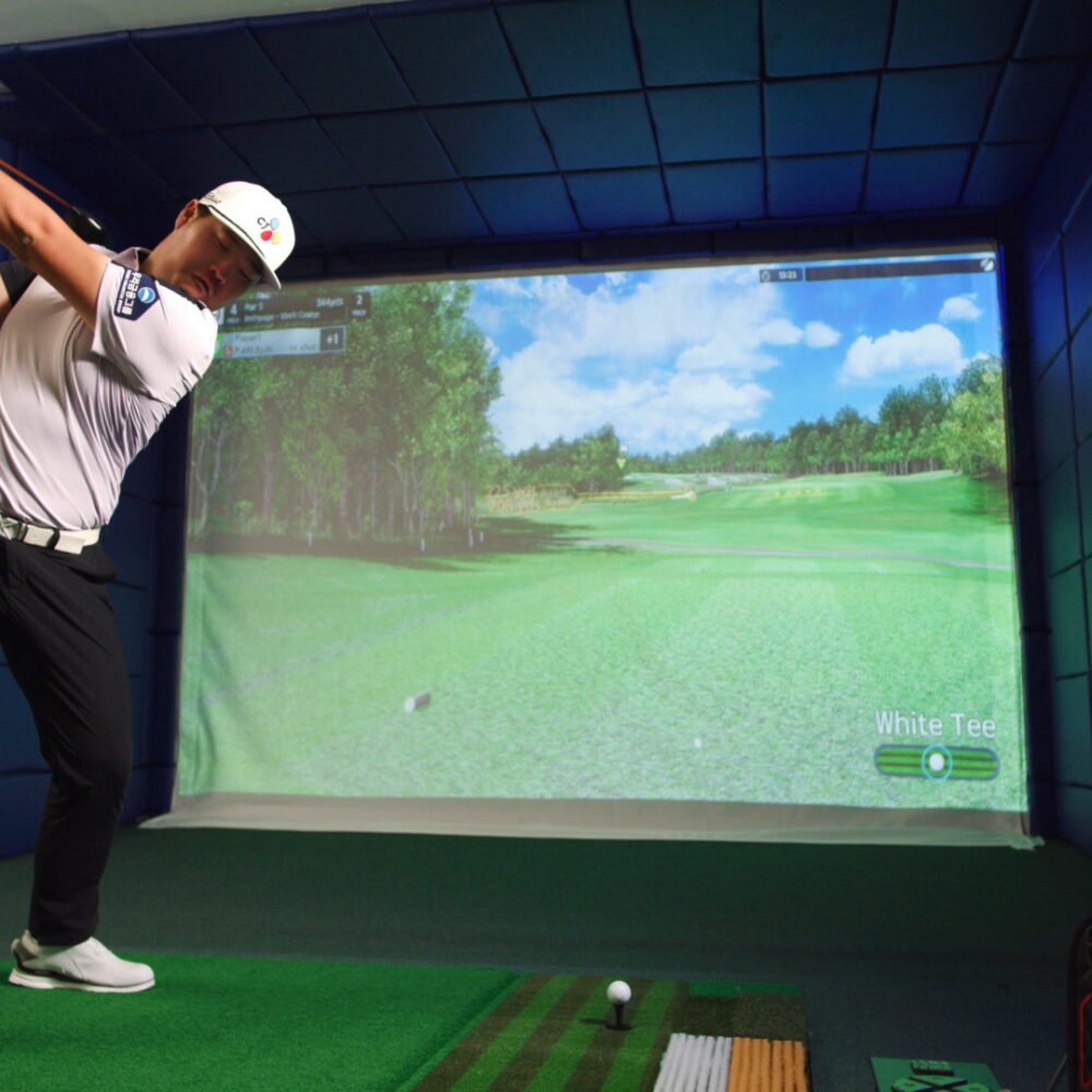 SJI Golfer Swinging Golf Club Playing on Golfzon Golf Simulator TwoVision