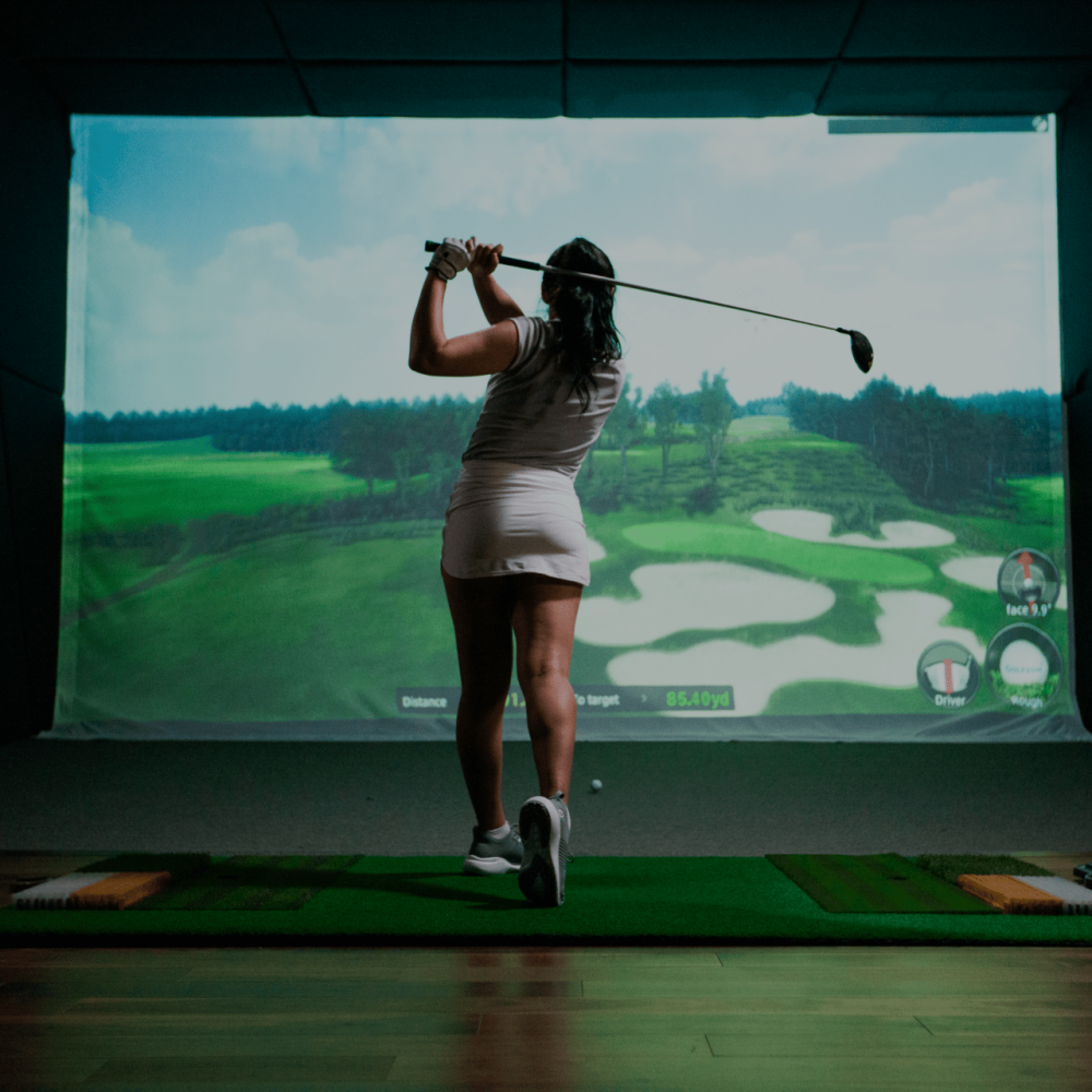 Female Golfer Swinging TwoVision Moving Swing Plate and Screen