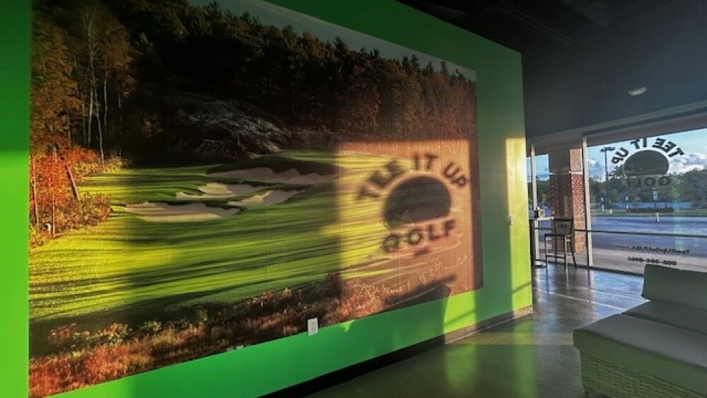 Tee It Up Golf Entrance, Reflection of Logo on Wall
