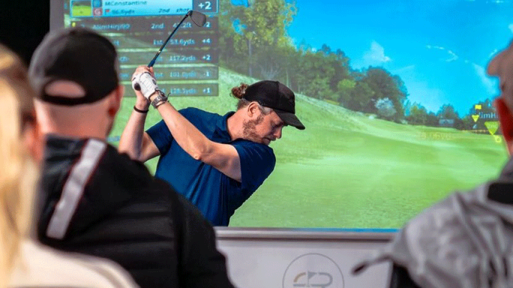 GOLFZON Tour - The Golf Rooms Golfer Swinging and Spectators Watching